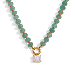 Green beaded necklace with clear square pendant