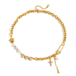 Gold-tone mixed-link necklace with imitation pearls, three heart-shaped stones, a star accent, a zircon cross charm, and a dangling gold-tone drop.
