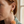Cream-and-gold sculptural earrings lifestyle image