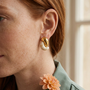 Cream-and-gold sculptural earrings lifestyle image