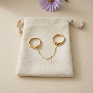 Crystal Chain-Linked Double Ring on the merchant’s cream simple pouch with a lavender aster