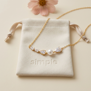 Glass Pearl & Cubic Zirconia Teardrop Necklace on the original simple pouch with blush cosmos
