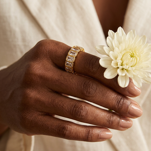 Multi Zircon Band Ring lifestyle close-up with rectangular stones and an ivory chrysanthemum