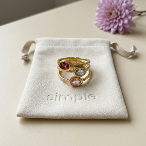 Multicolor Zircon Textured Triple-Band Ring on the original simple pouch with a lavender chrysanthemum