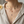 Necklace-only lifestyle image with linen-colored blouse
