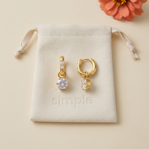 Round Zircon Drop Huggie Earrings on the original simple pouch with a coral zinnia