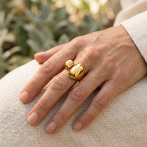 Square lifestyle close-up focused on the gold ring