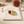 Tiger’s Eye & Quartz Open Ring on the cream simple pouch with a blurred autumn flower