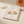 Topaz & Crystal-Tone Zircon Stud Earrings on the cream simple pouch with a peach dahlia