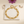 Triangle Zircon Tennis Bracelet on the original simple pouch with plum cosmos