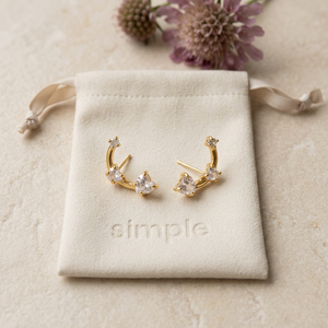 Triple Heart Zircon Curved Stud Earrings on the original simple pouch with mauve scabiosa