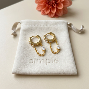 Zircon-Accent Chain Huggie Earrings on pouch