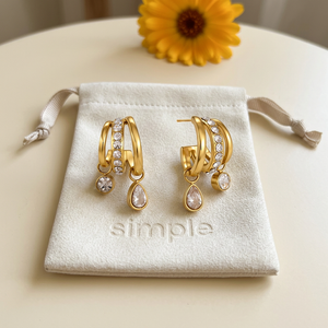 Zircon Rhinestone Multi-Layer Huggie Earrings on the original simple pouch with golden calendula